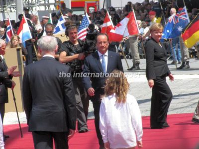 Heads of state (chancelor Angela Merkel here, leaving the red carpet) took turns greeting President François Hollande and WWII D-Day veterans