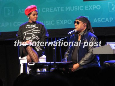 Janelle Monáe (L) listens to Stevie Wonder (R)